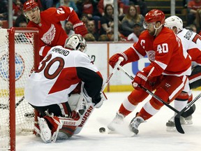 Ottawa Senators goalie Andrew Hammond (30) stops a shot by Detroit Red Wings left wing Henrik Zetterberg (40) in the second period of an NHL hockey game in Detroit Tuesday, March 31, 2015. (AP Photo/Paul Sancya)