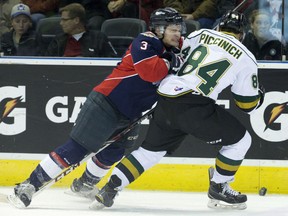Windsor Spitfires defenceman Liam Murray lays a hit on London Knights forward JJ Piccinich during their OHL hockey game at Budweiser Gardens in London, Ont. on Friday October 30, 2015. Craig Glover/The London Free Press/Postmedia Network