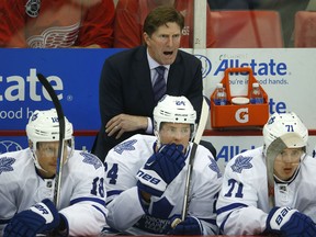 Toronto Maple Leafs head coach Mike Babcock gives instruction from the bench against the Detroit Red Wings in the first period of a preseason NHL hockey game in Detroit Friday, Oct. 2, 2015. (AP Photo/Paul Sancya)