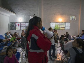 A members of the Red Cross speaks to evacuees remain at a shelter  in Puerto Vallarta, Mexico on October 23 ,2015, during hurricane Patricia. Monster Hurricane Patricia roared toward Mexico's Pacific coast on Friday, prompting authorities to evacuate villagers, close ports and urge tourists to cancel trips over fears of a catastrophe. The US National Hurricane Center called Patricia the strongest eastern north Pacific hurricane on record. It said the storm will make a potentially catastrophic landfall later Friday in southwestern Mexico.