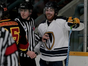 University of Windsor Lancers Ryan Green, right, smiles while being separated from Guelph Gryphons Scott Simmonds in OUA playoff hockey at South Windsor Arena February 25, 2015. (NICK BRANCACCIO/The Windsor Star)