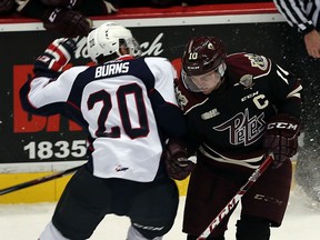 The Windsor Spitfires Andrew Burns collides with the Peterborough Petes Eric Cornel at the WFCU Centre in Windsor on Thursday, October 8, 2015.                                      (TYLER BROWNBRIDGE/The Windsor Star)