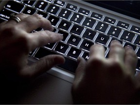 A person types on a computer keyboard.