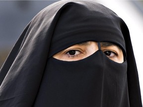 A woman wears a niqab as she walks September 9, 2013 in Montreal.