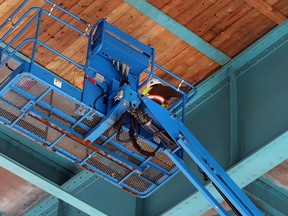 Workers install a layer of lumber under the Ambassador Bridge over Donnelly Street in Windsor, Ont. on Oct. 20, 2015.   Wyandotte Street, Donnelly Street, and Peter Street remain closed.