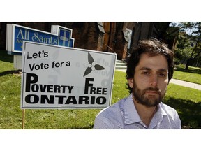 File photo of Adam Vasey with an anti-poverty message at All Saints' Church, part of a sign campaign encouraging all Ontario political parties to make poverty elimination an election issue. (NICK BRANCACCIO/Windsor Star)