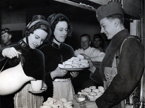 Salvation Army volunteers serve doughnuts and coffee to local soldiers in 1940.