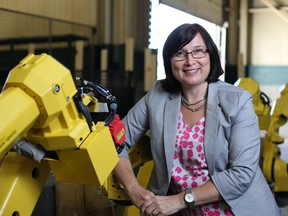 Shelley Fellows is shown with industrial robotics at her company, Radix  Inc. - John Chan: Special to Windsor Star