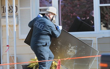 A Windsor Police Service investigator is shown at the scene of a house fire at 1680 Balfour Blvd. in Windsor, Ont. on Monday, Oct. 26, 2015.