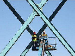 A couple of workers are shown at the Ambassador Bridge on Thursday, Oct 22, 2015.