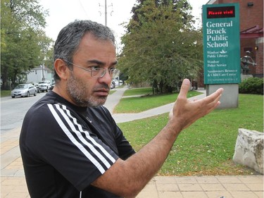Oscar Marquez, a parent of a child at General Brock Public School speaks Tuesday, Oct. 6, 2015, in front of the school about the cockroach situation that closed the cafeteria recently. (DAN JANISSE/The Windsor Star) (For story by Carolyn Thompson)