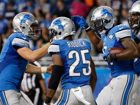 Wide receiver Calvin Johnson #81 of the Detroit Lions is congratulated by quarterback Matthew Stafford #9 after catching a six-yard touchdown reception against the Chicago Bears during the fourth quarter of the NFL game at Ford Field on Sunday, Oct. 18, 2015 in Detroit, Mich.   The Lions defeated the Bears 37-34 in overtime.