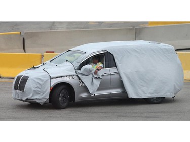A blanketed minivan is shown at the Fiat Chrysler Automotive's Windsor Assembly Plant on Oct. 6, 2015.
