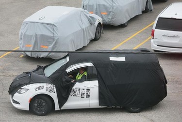 Blanketed minivans are shown at the Fiat Chrysler Automotive's Windsor Assembly Plant on Oct. 6, 2015.