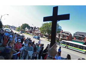 Approximately 50 people protest the removal of a large steel cross from Hotel-Dieu Grace Hospital on Ouellette Ave., Friday, Sept. 27, 2013.  The cross is being transferred to the Tayfour Campus which will be named Hotel-Dieu Grace Healthcare.  (DAX MELMER/The Windsor Star)