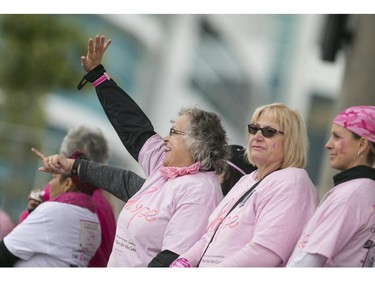 Cancer survivors stand on stage during the ceremony at the Canadian Breast Cancer Foundation CIBC Run for the Cure at the Riverfront Festival Plaza, Sunday, Oct. 4, 2015.  (DAX MELMER/The Windsor Star)