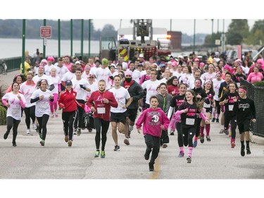 Runners sprint from the starting line at the Canadian Breast Cancer Foundation CIBC Run for the Cure at the Riverfront Festival Plaza, Sunday, Oct. 4, 2015.  (DAX MELMER/The Windsor Star)