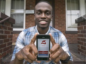 Andre Wright, 21, a fourth-year kinesiology student at the University of Windsor, holds up a mobile dating app, Suited, that he created.