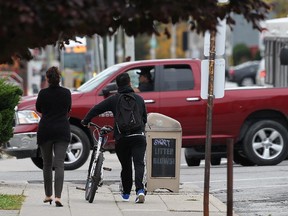 Pedestrians are shown on University Avenue near downtown Windsor, Ont. on Tuesday, Oct. 13, 2015.