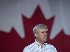 Conservative leader Stephen Harper pauses for a moment as he addresses a gathering during a campaign event in Fredericton, N.B. Friday, Oct. 16, 2015.