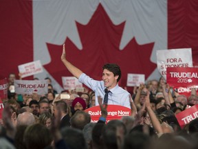 Liberal leader Justin Trudeau waves to supporters during a rally Sunday, October 18, 2015 in North Vancouver.