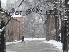 In this Jan. 26, 2015 file picture  a person walks near the entrance to the former Nazi Death Camp complex of  Auschwitz in Oswiecim, Poland.