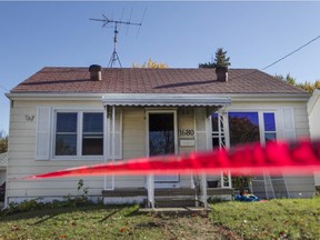 Red tape surrounds the side of home at 1680 Balfour Blvd. where a fire was intentionally set in the early morning, Sunday, Oct. 25, 2015.