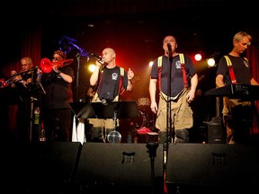 Members of Firesound - a band whose members are all Toronto firefighters - performing onstage in July 2015.