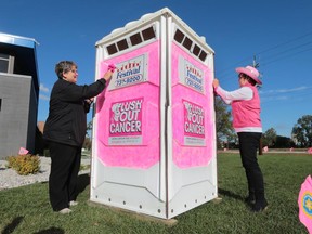 WINDSOR, ONTARIO, OCTOBER 1, 2015 - The Windsor/Essex office of the Canadian Cancer Society kicked off breast cancer awareness month on Thursday, Oct. 1, 2015, with a new campaign called "Flush out cancer". A pink port-a-potty was placed at Centerline in Windsor, ON. To get the pink potty off the front lawn of the business employees needed to raise at least $100 dollars which they quickly surpassed. The company then gets to choose where the potty goes next. Kelly O'Rourke (L) from the Canadian Cancer Society and Dorie Deslippe, an employee an CenterLine decorate the potty for the event. (DAN JANISSE/The Windsor Star)