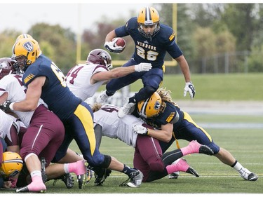 Windsor's Terrence Crawford leaps over the McMaster defence for a touchdown as the Windsor Lancers host the McMaster Marauders during OUA football action at Alumni Field, Saturday, Oct. 3, 2015.  (DAX MELMER/The Windsor Star)