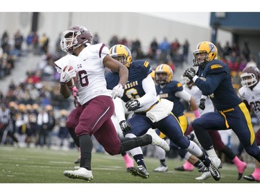 McMaster's Aaron Baker runs for extra yards as the Windsor Lancers host the McMaster Marauders during OUA football action at Alumni Field, Saturday, Oct. 3, 2015.  (DAX MELMER/The Windsor Star)