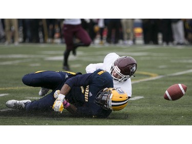 Windsor's Dave McDuffie is tackled by McMaster's Adam Poole after he dropping a pass as the Windsor Lancers host the McMaster Marauders during OUA football action at Alumni Field, Saturday, Oct. 3, 2015.  (DAX MELMER/The Windsor Star)
