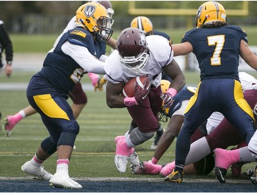 McMaster's Wayne Moore, centre, rushes for a touchdown as the Windsor Lancers host the McMaster Marauders during OUA football action at Alumni Field, Saturday, Oct. 3, 2015.  (DAX MELMER/The Windsor Star)