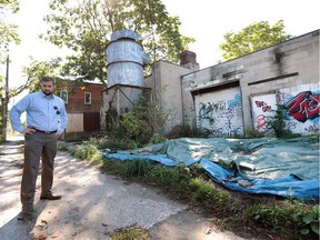 Community planner T.J. Auer, who is with the Ford City Neighbourhood Renewal organization, is calling on Windsor to follow Hamilton's lead and start a vacant building registry to push owners of vacant properties to fill them.   Auer is shown near vacant property on Drouillard Road next to vacant commercial property.
