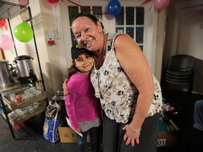 Gabby Wilkinson, 9, is shown with Street Help administrator Christine Wilson-Furlonger on Friday, Oct. 2, 2015, at the organization in Windsor, ON. The youngster regularly collects goods for the homeless shelter. The staff and users of the homeless shelter decided to throw her a surprise birthday party today when she showed up to deliver goods.