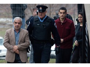 In this file photo, Mohammad Shafia (L), Hamed Shafia and Tooba Mohammad Yahya leave the holding cell at the Frontenac county courthouse in Kingston, Ont. December 13, 2011. Shafia, wife Tooba Mohammad Yahya and their adult son Hamed Mohammad Shafia are on trial for the first-degree murder of Shafia's daughters Zainab, 19, Sahar, 17, and Geeti, 13 and his first wife Rona Amir Mohammad. Their bodies were found inside the family Nissan Sentra in Kingston Mills Locks on June 30, 2009.  (Lars Hagberg / MONTREAL GAZETTE)