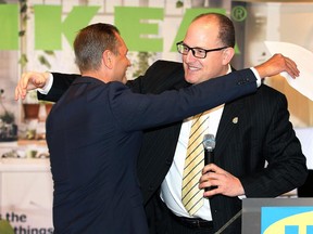 Stefan Sjostrand, left, president of IKEA Canada, hugs Windsor Mayor Drew Dilkens during a news conference Wednesday, Oct. 14, 2015 at Willistead Manor in Windsor, Ont. IKEA Canada announced that they have secured a location on Walker Road for a Pick-Up and Order Point facility.