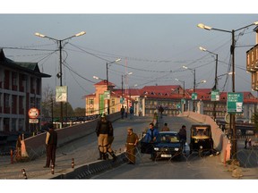 Commuters are stopped at a road block by Indian paramilitary soldiers as restrictions are put into place ahead of a planned Muharram procession in Srinagar on October 22, 2015. Authorities on October 22 imposed restrictions in parts of Srinagar, the summer capital of Kashmir, to thwart planned Muharram processions.