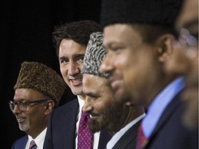 Liberal Leader Justin Trudeau, second left, poses for a photo with dignitaries at the Ahmadiyya Muslim Jama'at Conference in Mississauga, Ont., as he continues his federal election campaign on Saturday, August 28, 2015.