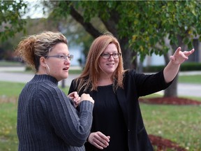 NDP MP-elect Tracey Ramsey, right, waves to well-wishers while chatting with campaign assistant Jessica John in Belle River, Tuesday, Oct. 20, 2015.