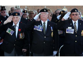 WINDSOR, ONT.: JULY 16, 2011 -- From left, Stan Scislowski, a WW2 veteran, Gordon Moore, Dominion First Vice President, and Brian Weaver, Ontario Command Vice President, salute the flag at the grand opening of the Royal Canadian Legion Metropolitan Branch 594's new building in Windsor, Saturday, July 16, 2011.     (DAX MELMER / The Windsor Star)