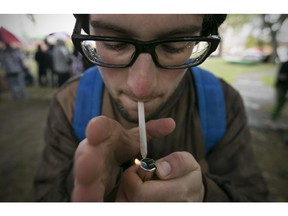 WINDSOR, ON.: OCTOBER 4, 2015 -- Reed Johnson, 20, lights up a marijuana cigarette at the 3rd annual Marijuana March and Cannabis Culture Fest in downtown Windsor, Saturday, Oct. 3, 2015. (DAX MELMER/The Windsor Star)