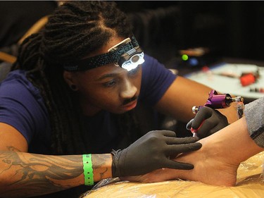 Tattoo artist Tim Stafford is shown during the Motor City Tattoo Expo in Detroit, Mich. on Saturday, March 7, 2015.