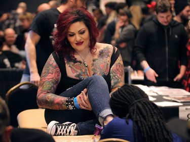 Tattoo artist Tim Stafford works on a tattoo during the Motor City Tattoo Expo in Detroit, Mich. on Saturday, March 7, 2015. Much of it was done by Belle River, Ont. artist John Wayne.
