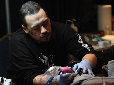 One of 400 tattoo artists is shown during the Motor City Tattoo Expo in Detroit, Mich. on Saturday, March 7, 2015.