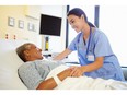 Nurse talking to senior woman in hospital room. Photo by fotolia.com.