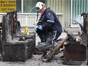 An investigator with the Ontario Fire Marshal is shown at the scene of a fire at The Original Pizza Brothers on Wyandotte St. E. on Tuesday, Oct. 13, 2015, in Windsor, ON. Officials classified the fire as suspicious.