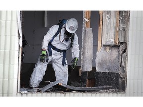 WINDSOR, ONTARIO - OCT 13, 2015 - An investigator with the Windsor Fire and Rescue Service is shown at the scene of a fire at The Original Pizza Brothers on Wyandotte St. E. on Tuesday, Oct. 13, 2015, in Windsor, ON. Officials classified the fire as suspicious. (DAN JANISSE/The Windsor Star)