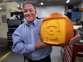 Mike Ouellette, skills trades training coordinator with Valiant International in Windsor, Ont. displays a pumpkin with a 3D image of Frankenstein. The high-tech carving was done with a CNC machine. The company is offering to carve custom logos into pumpkins to raise funds for a local student robotics group.