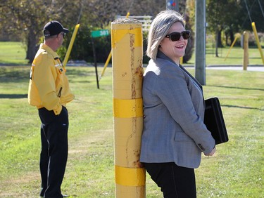 Provincial NDP leader Andrea Horwath is shown before a media conference on Friday, Oct. 16, 2015, in front of the former Honeywell plant in Amhertsburg, ON. A security guard, in background, ordered Horwath and members of the media off the company property and onto the sidewalk.